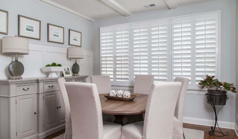 Plantation shutters are a perfect choice for homeowners looking for privacy or natural light. Plantation shutters in a New York dining room.